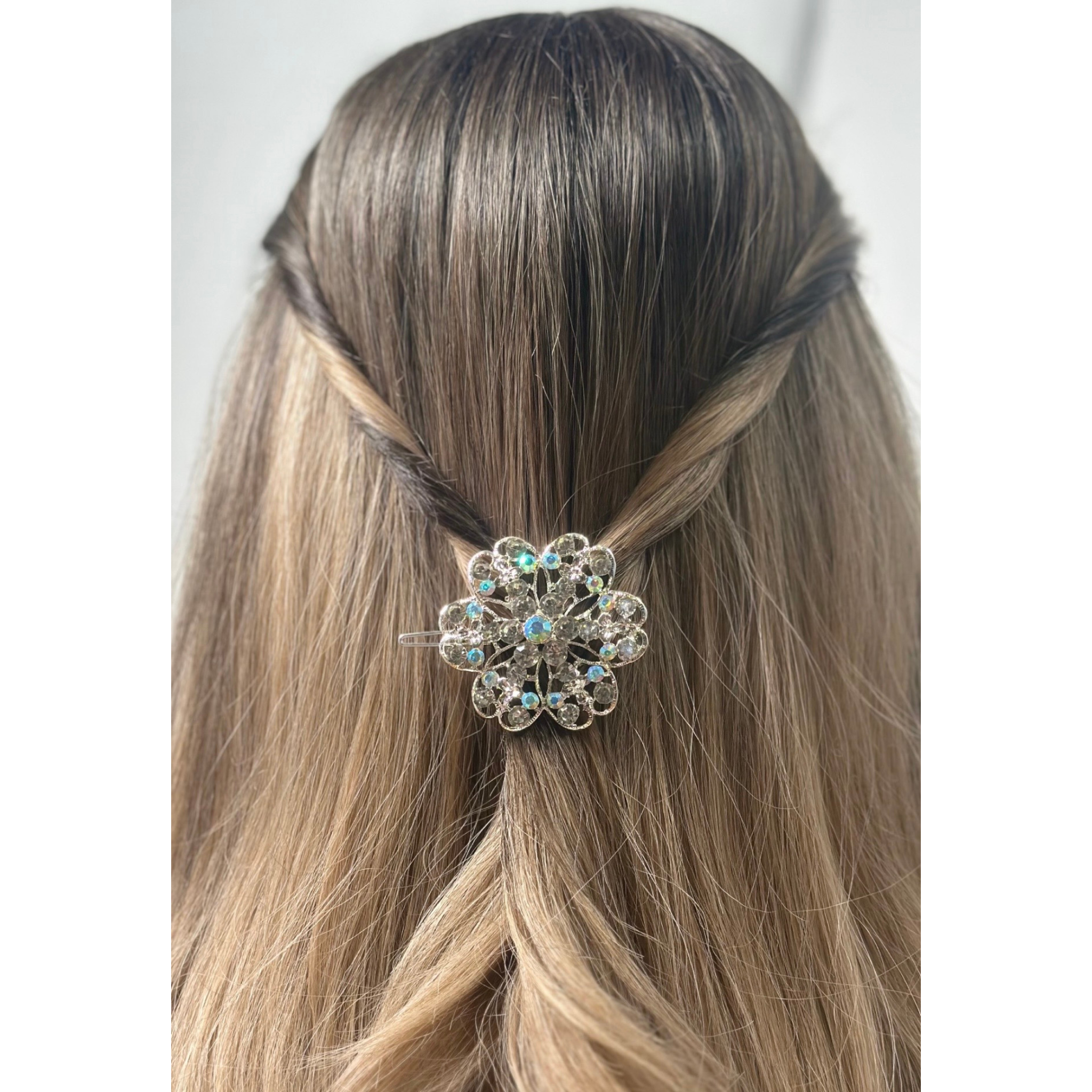 Hair accessory with a decorative flower design in a person's hair