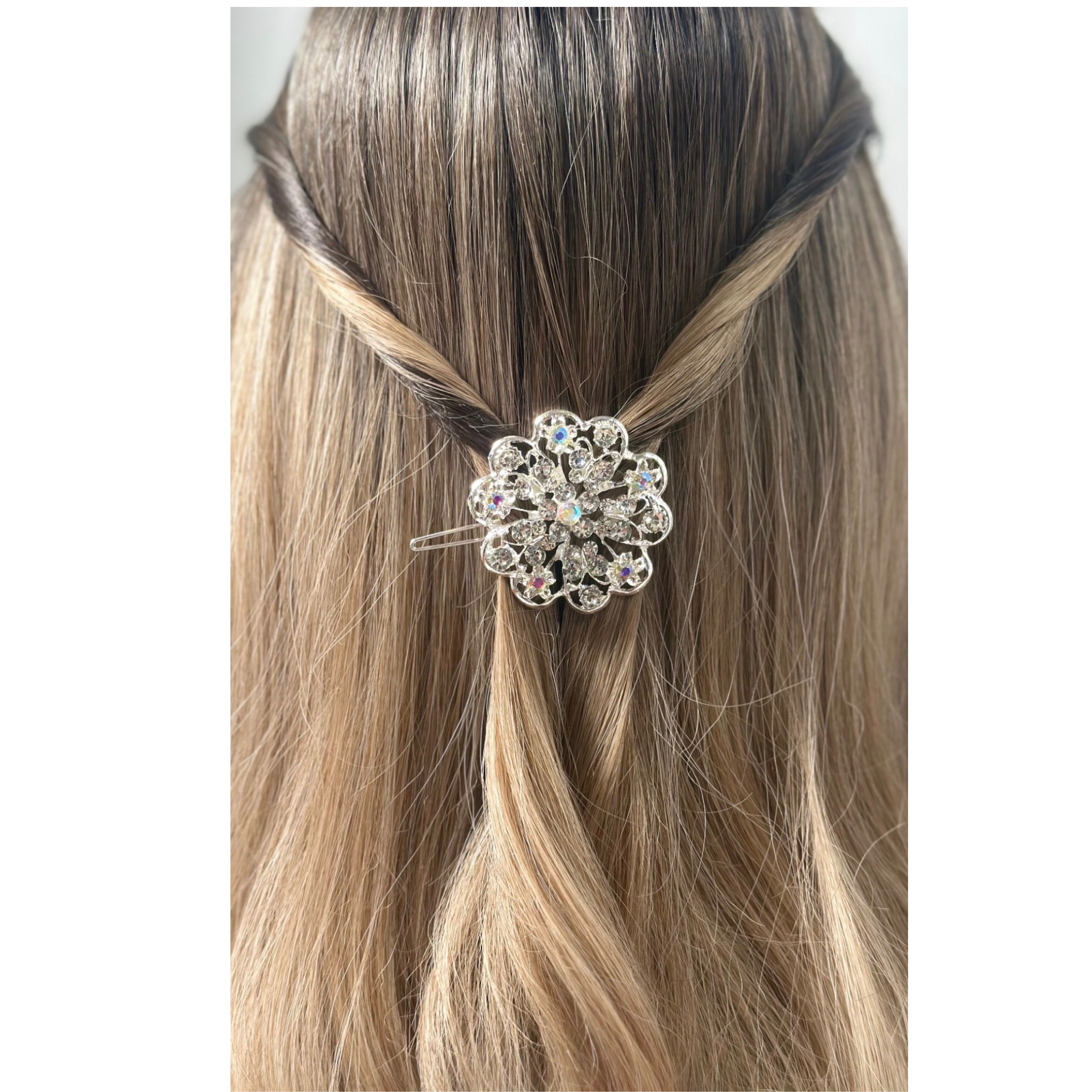 Hair accessory with a decorative flower design on a person's hair.