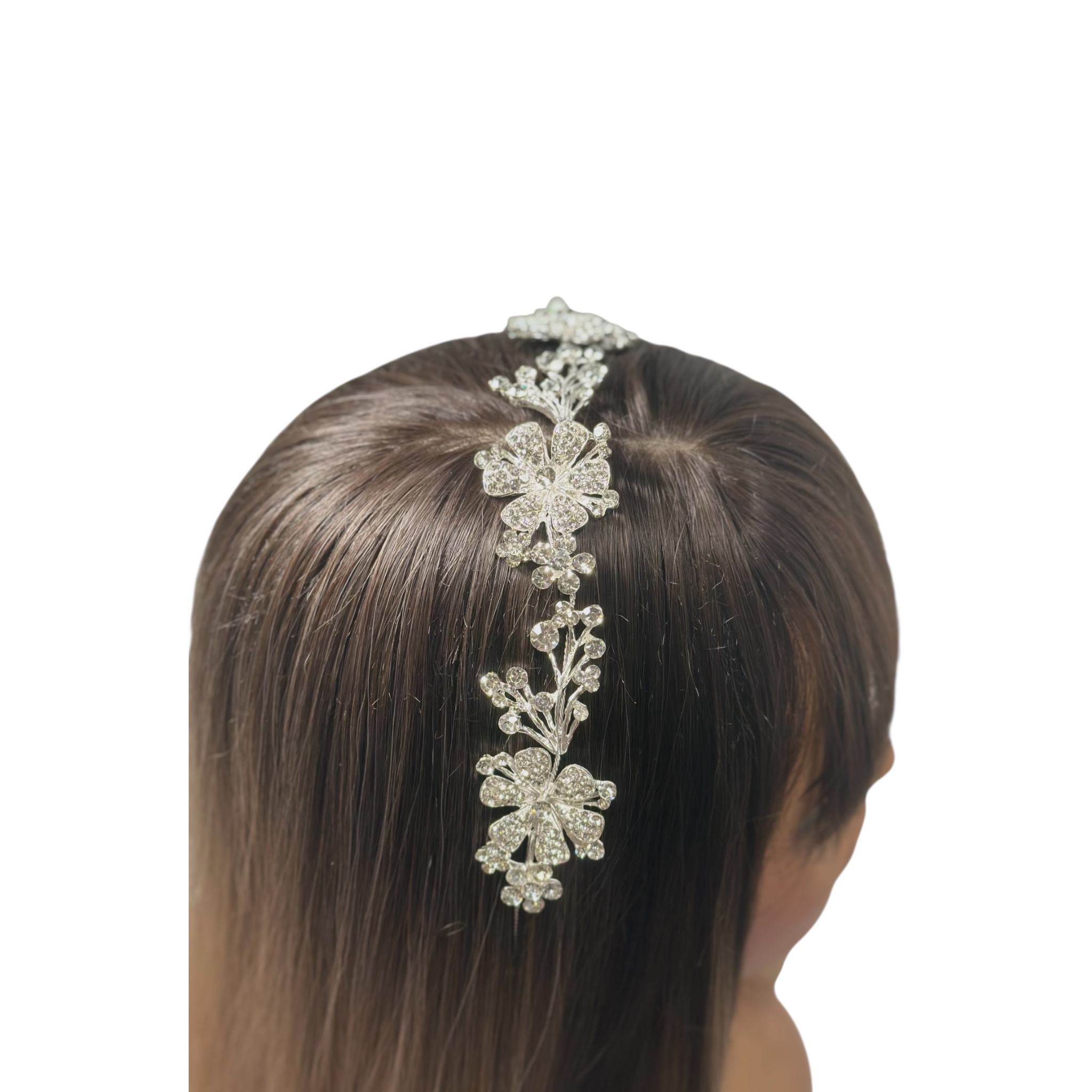 Silver floral headband accessory on a person's head against a white background