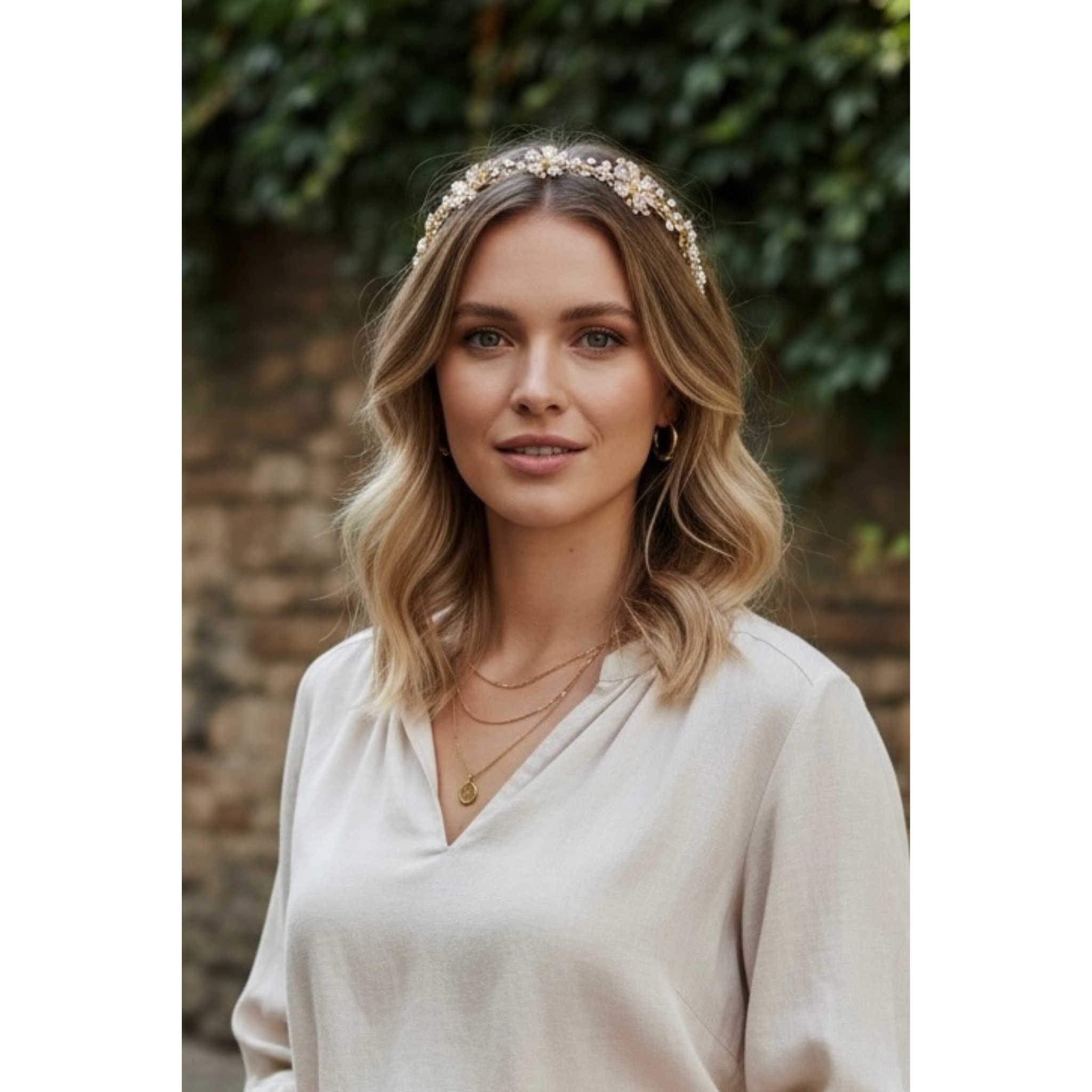 Woman wearing a floral headband with a blurred natural background