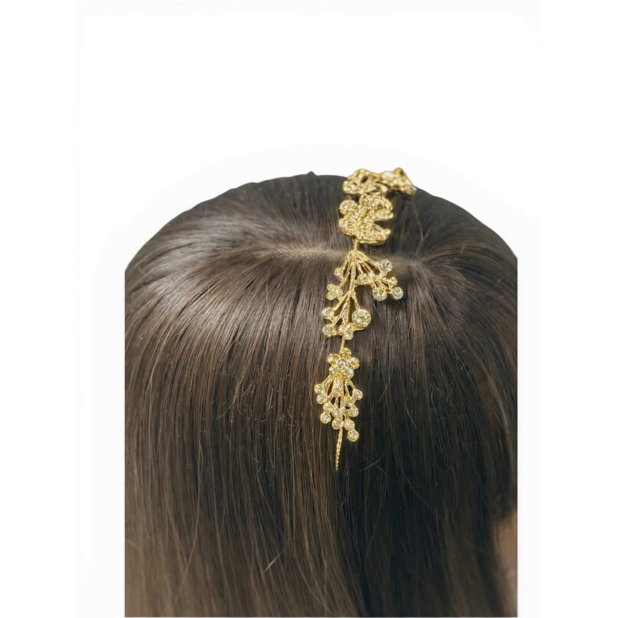 Gold hair accessory headband on a person's head with a plain background