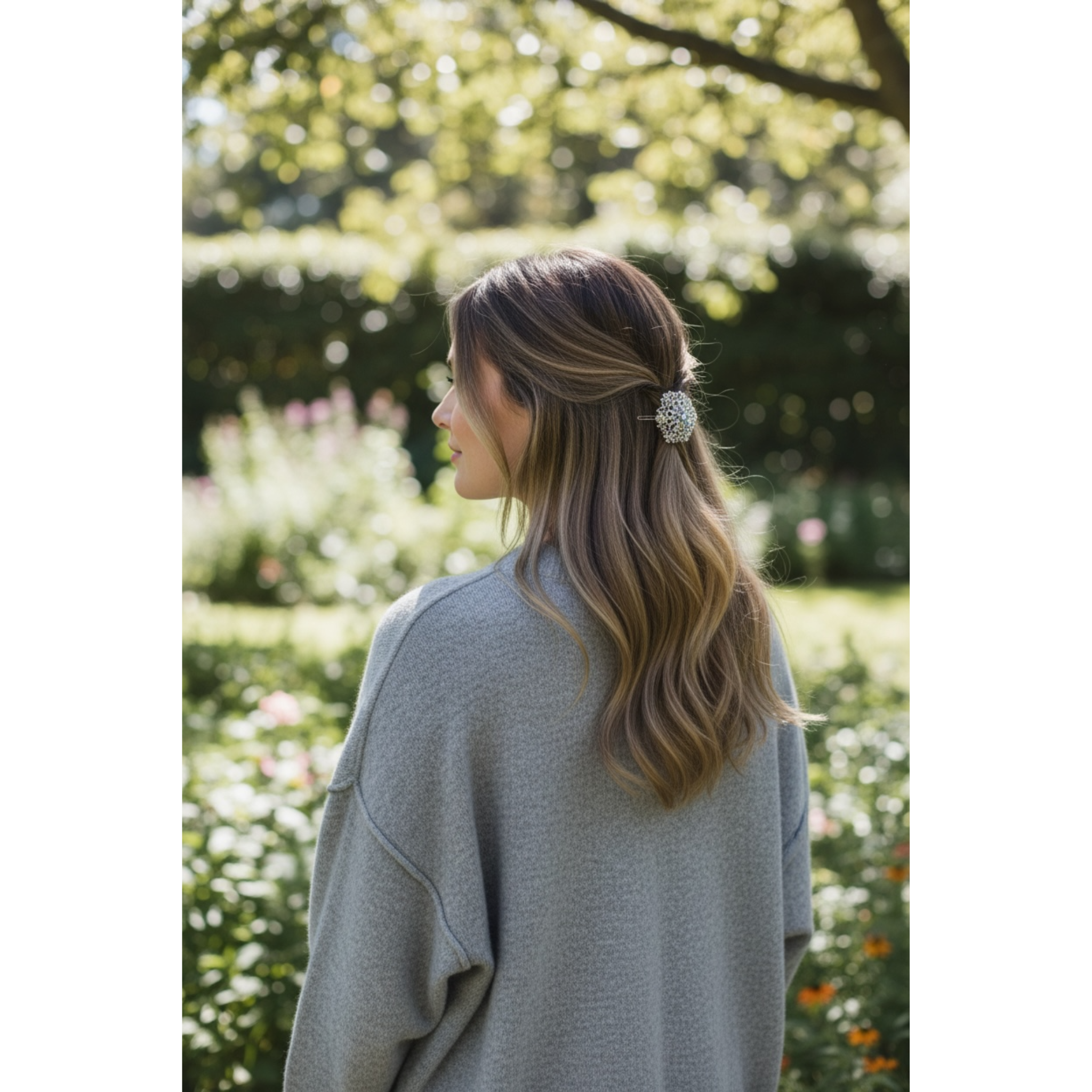 Woman with a decorative hair clip in a garden setting. This image highlights the decorative hair clip