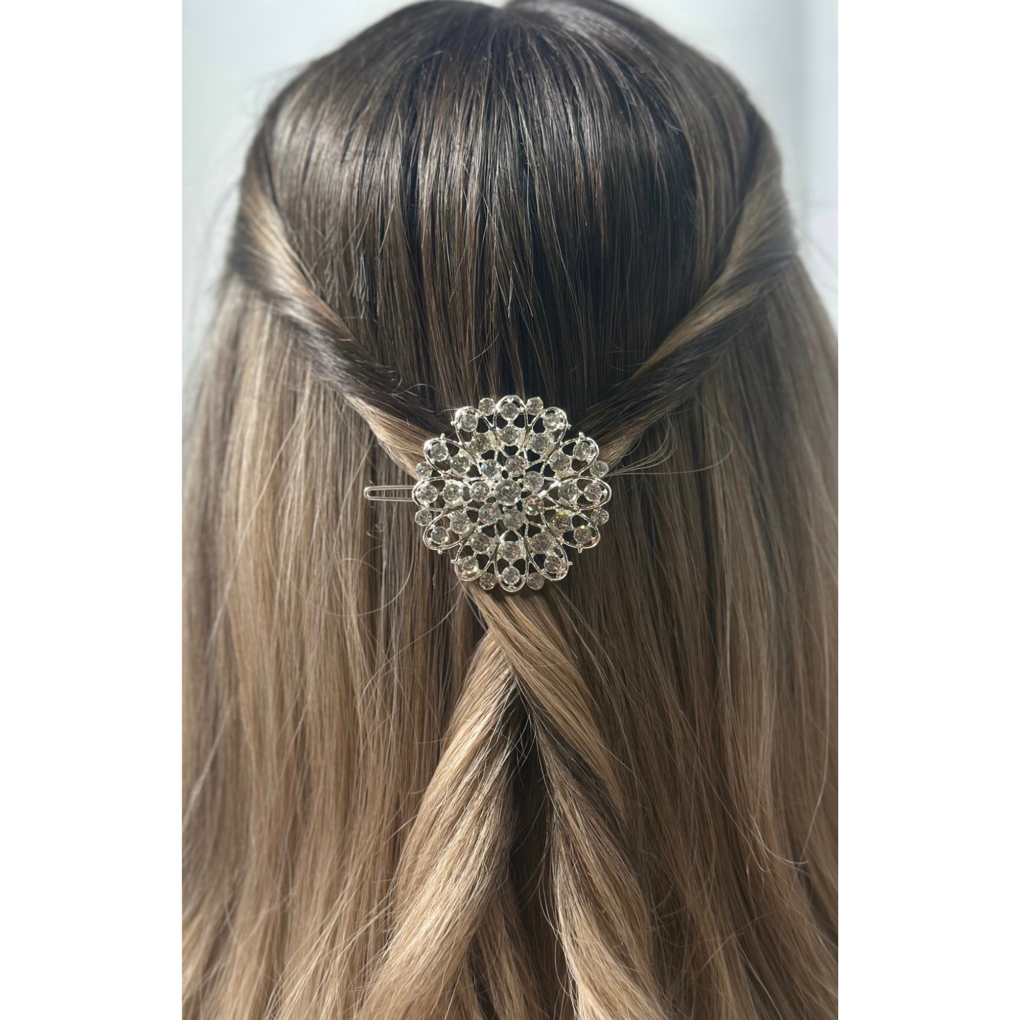 Hair accessory with decorative element on a person's hair against a white background