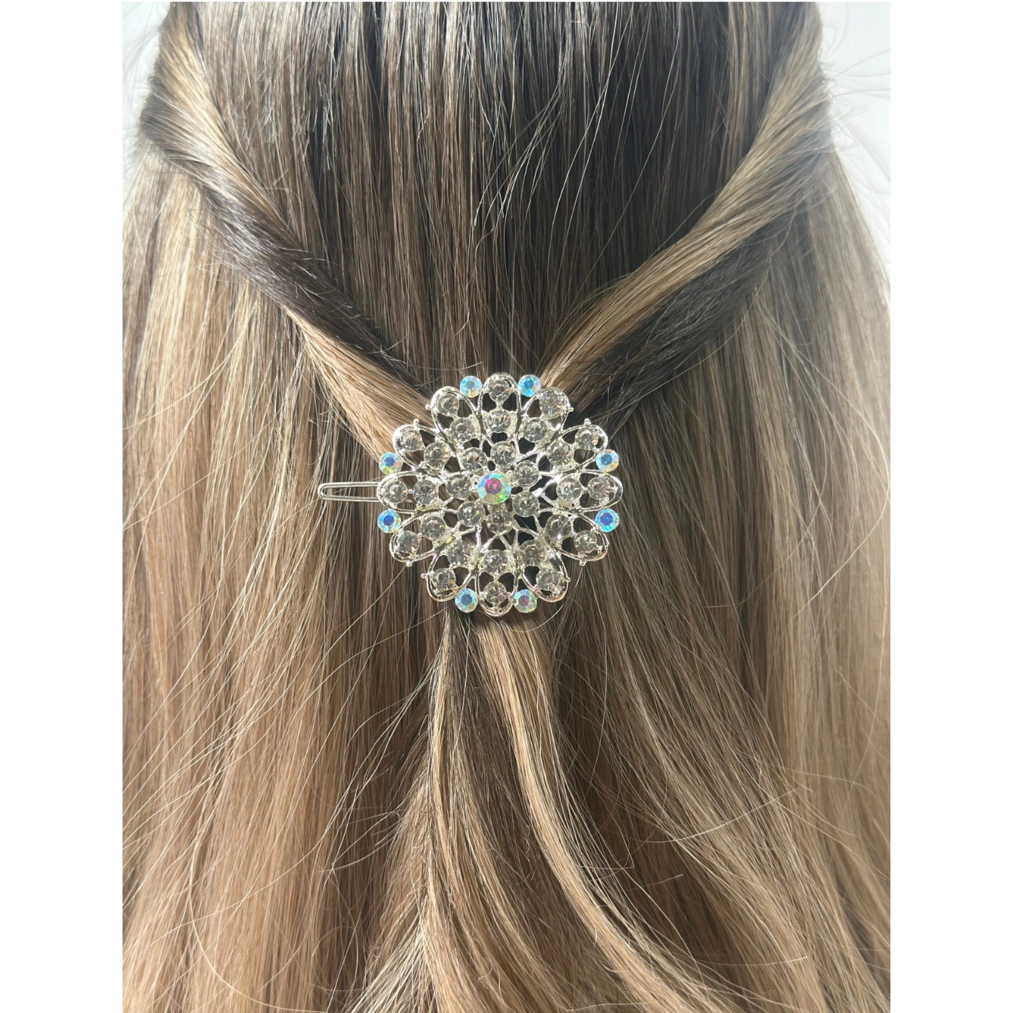 Decorative hair clip on a person's hair with a plain background