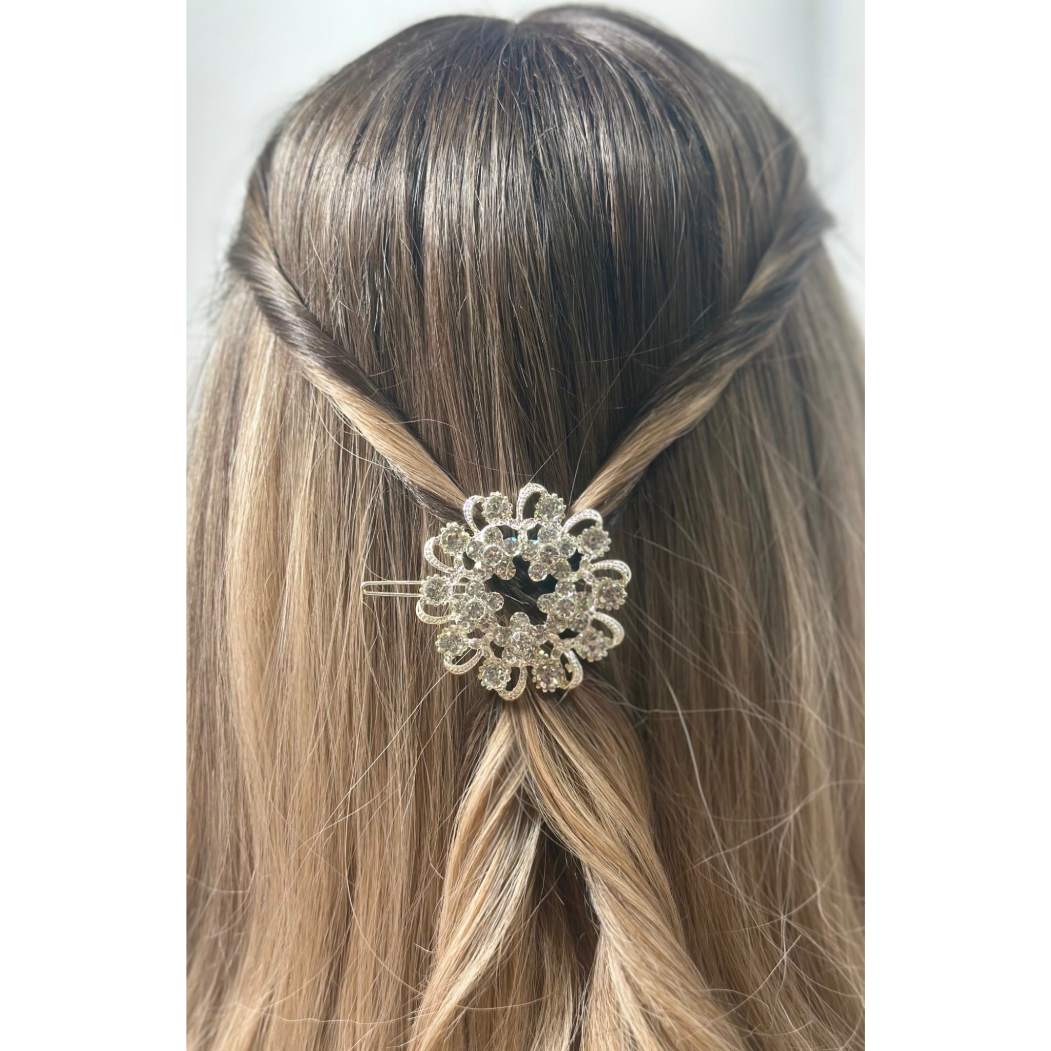 Hair accessory with decorative multicolor hair clip styled on hair on a plain background