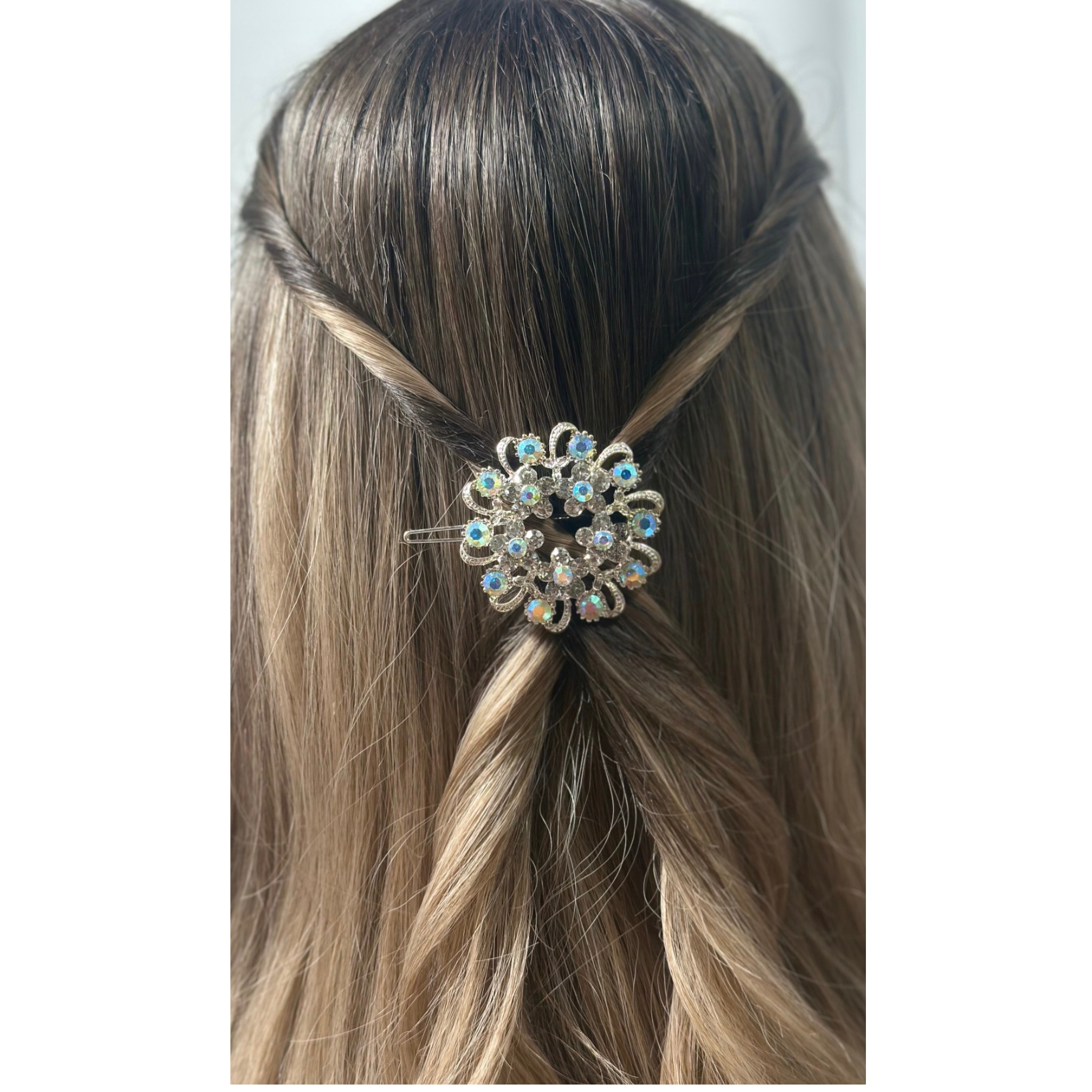 Hair accessory with decorative element in a person's hair on a white background