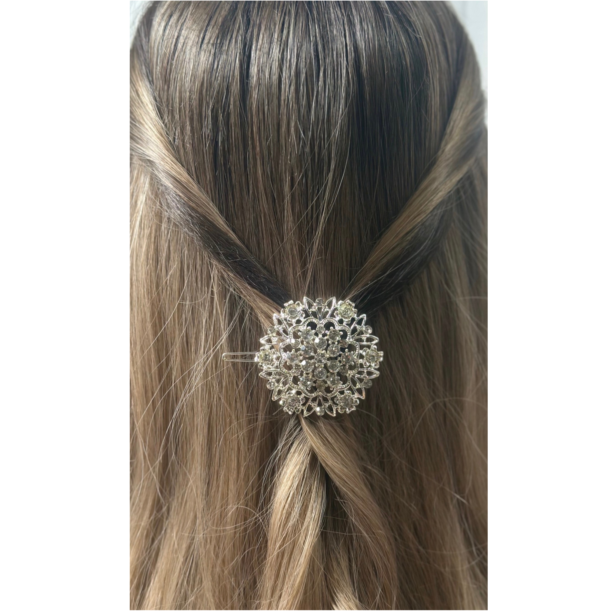 Silver hair accessory in a person's hair on a white background