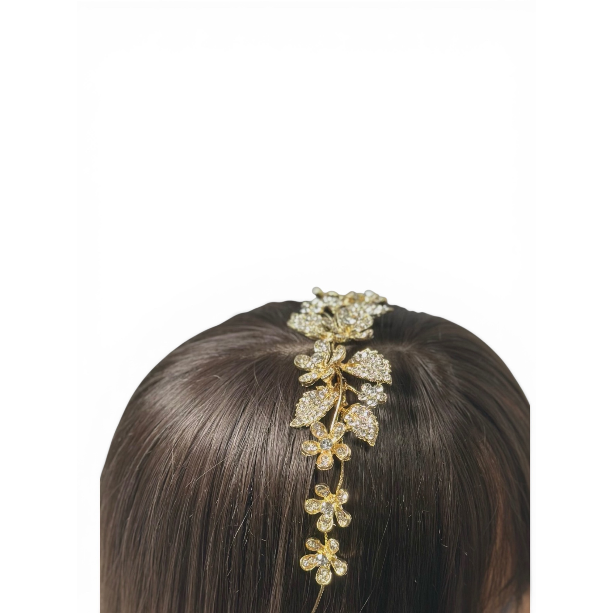 Gold floral shaped headband hair accessory on a woman's head against a white background