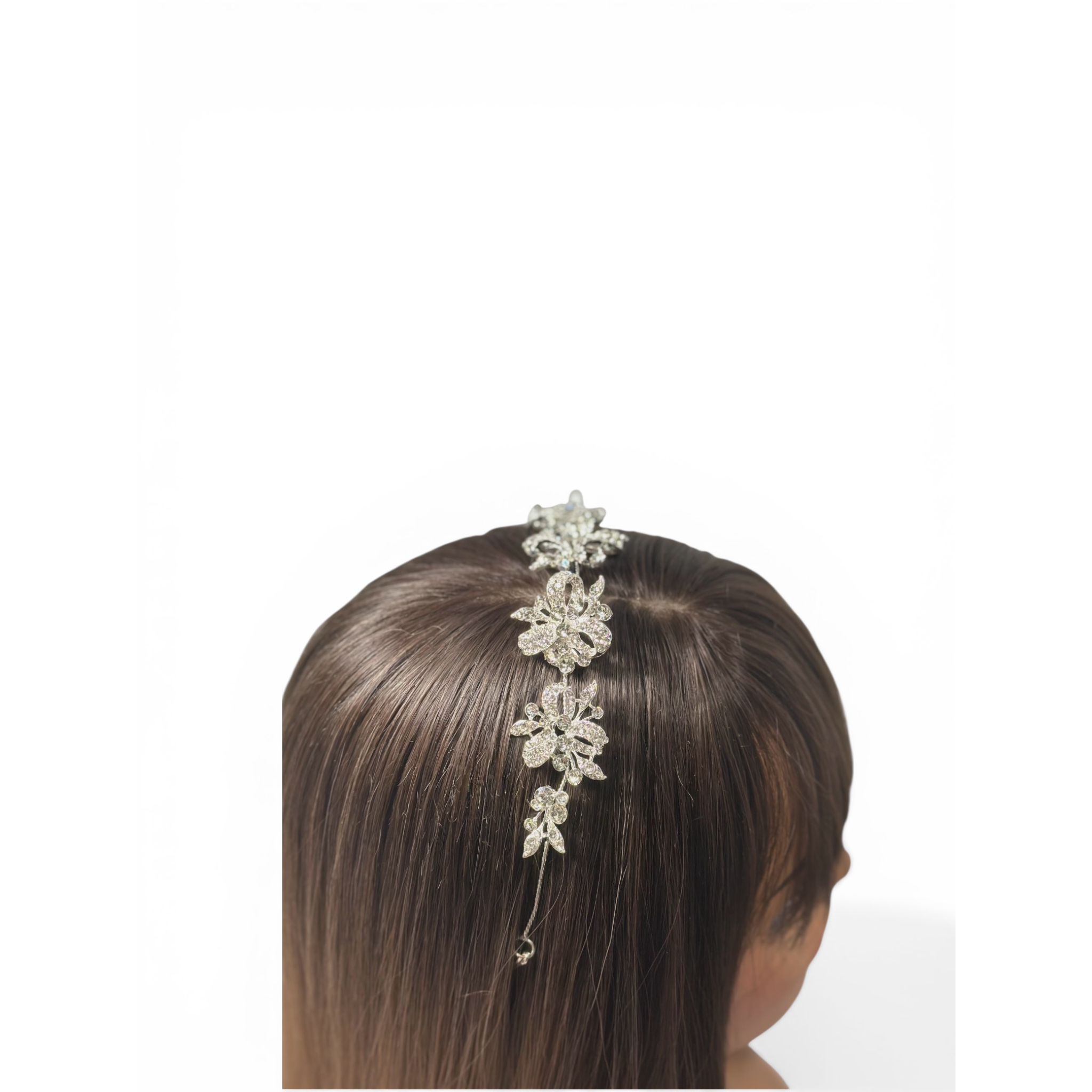 Decorative headband on a mannequin head with brown hair against a white background