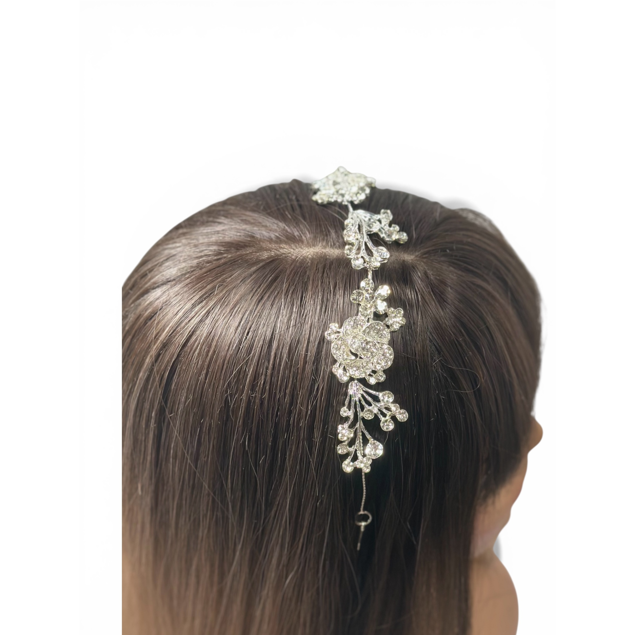 Decorative hair vine with crystals on a person's head against a white background