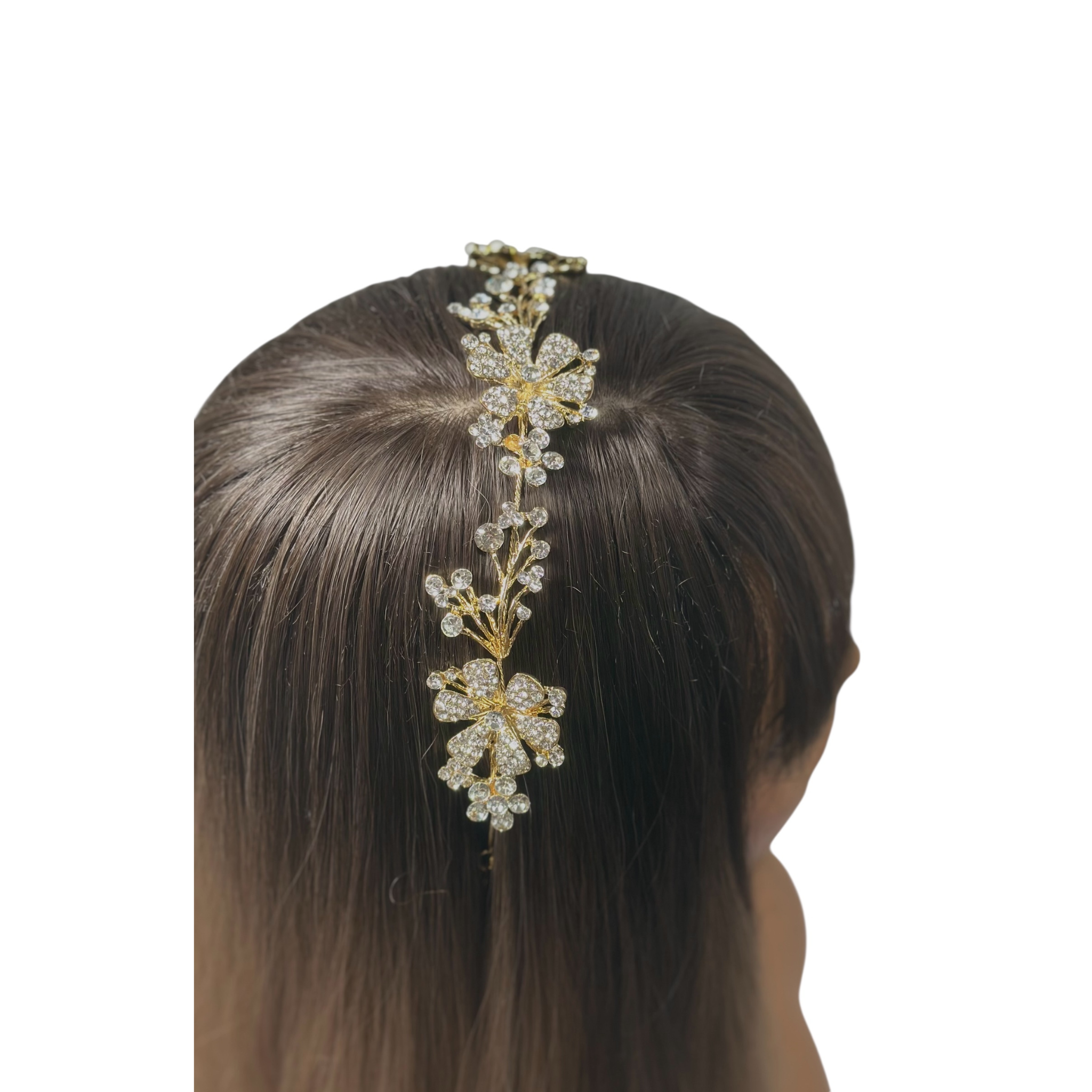 Gold floral headband accessory on a mannequin head with brown hair against a white background
