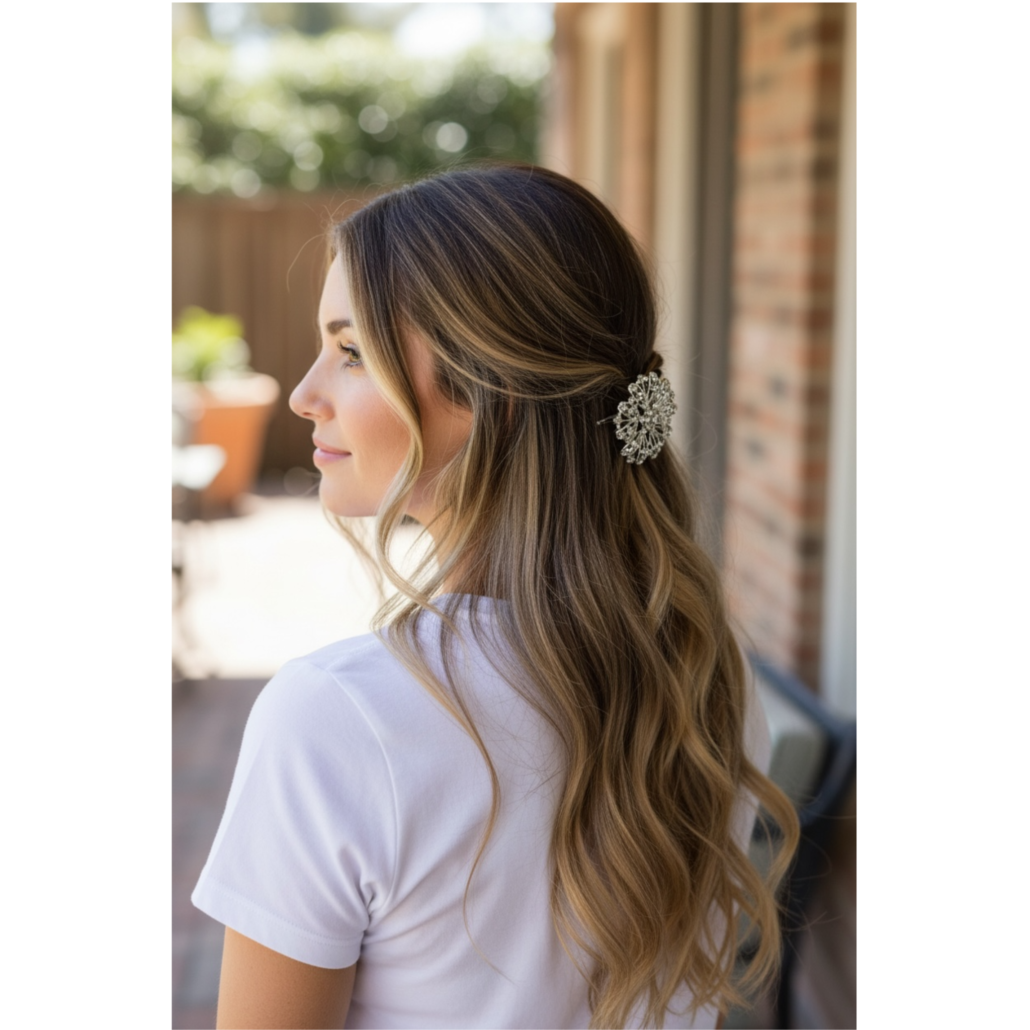 Woman with styled hair featuring a decorative hairpin outdoors.