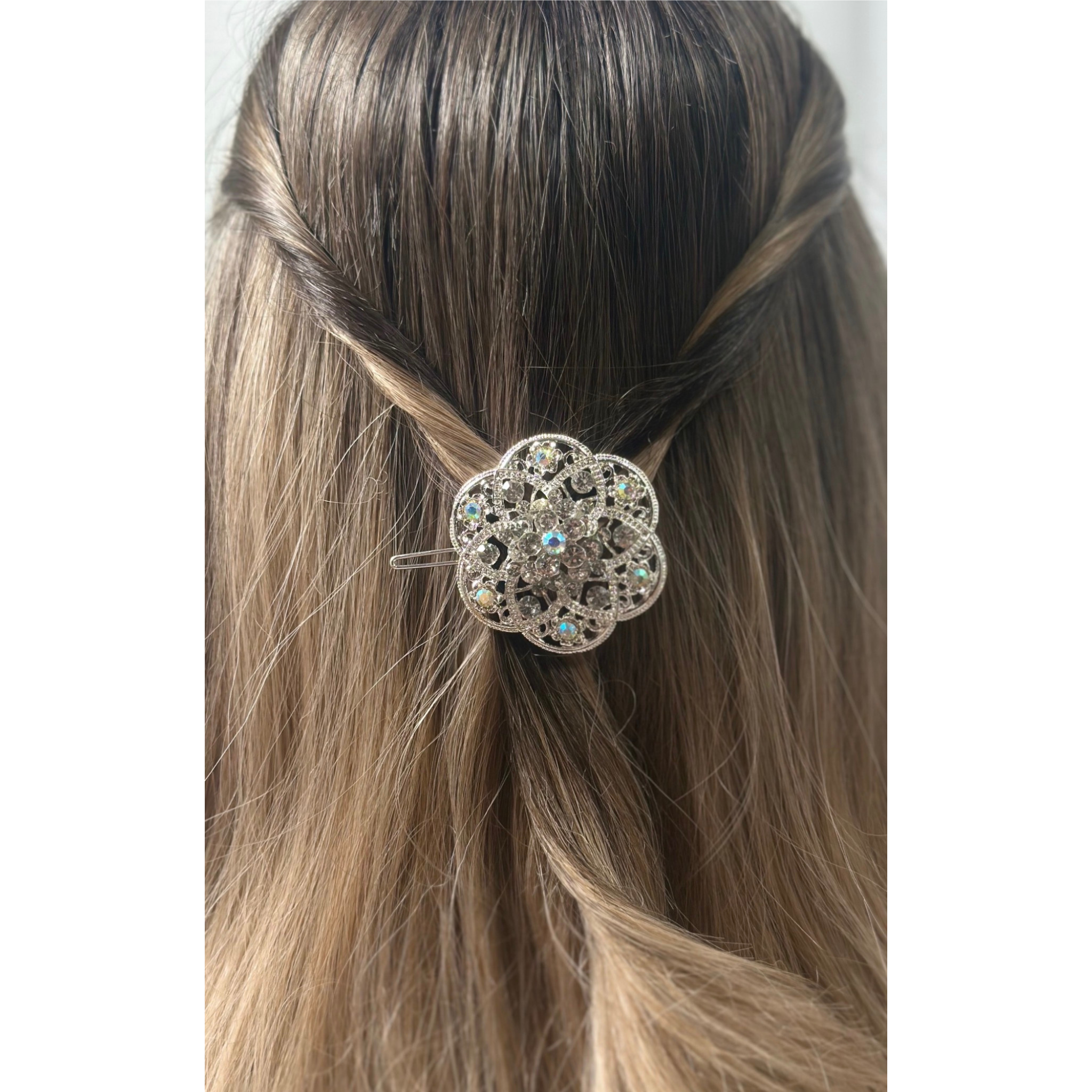 Decorative hair clip on a person's hair with a plain background