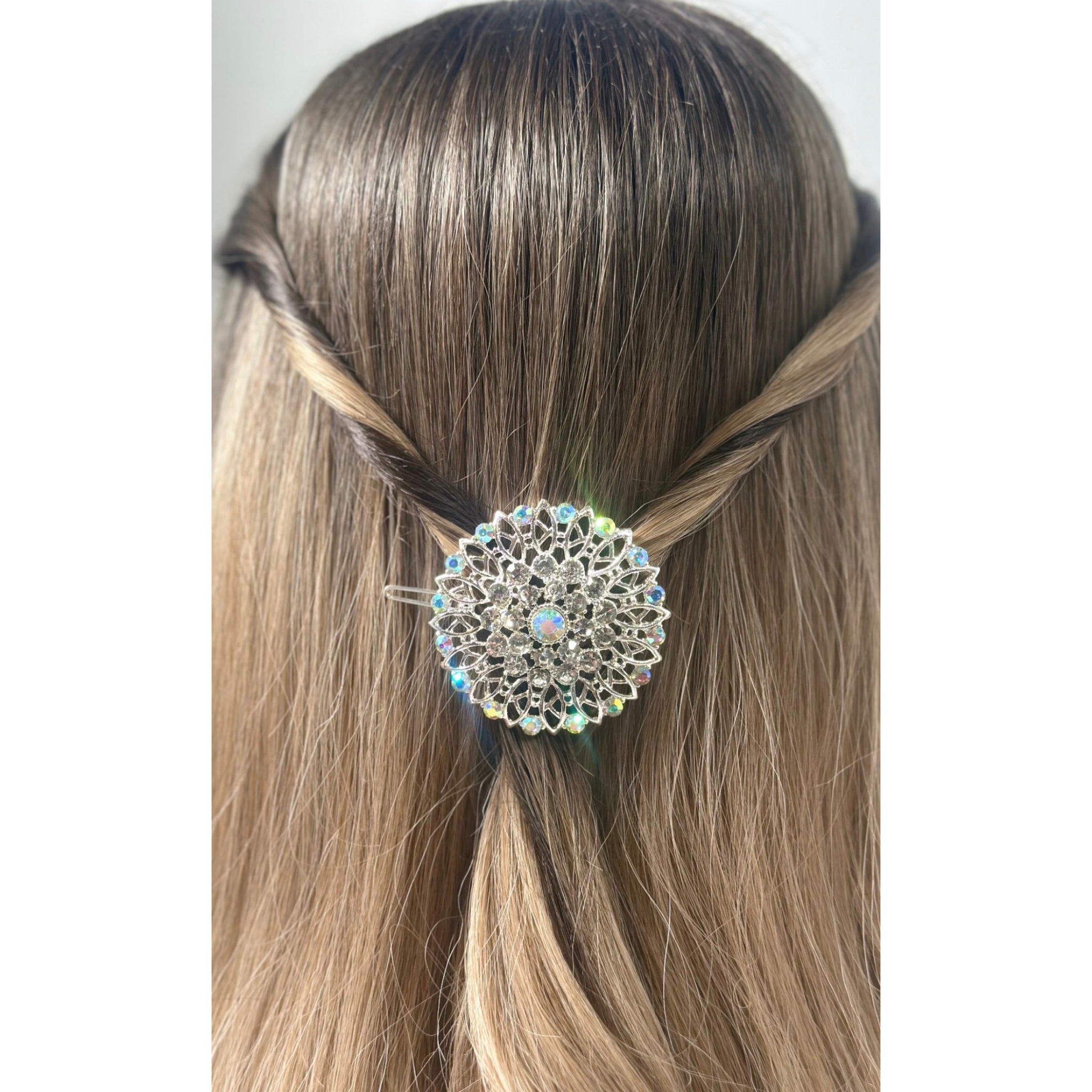 Hair accessory with a decorative element in a braid on a plain background