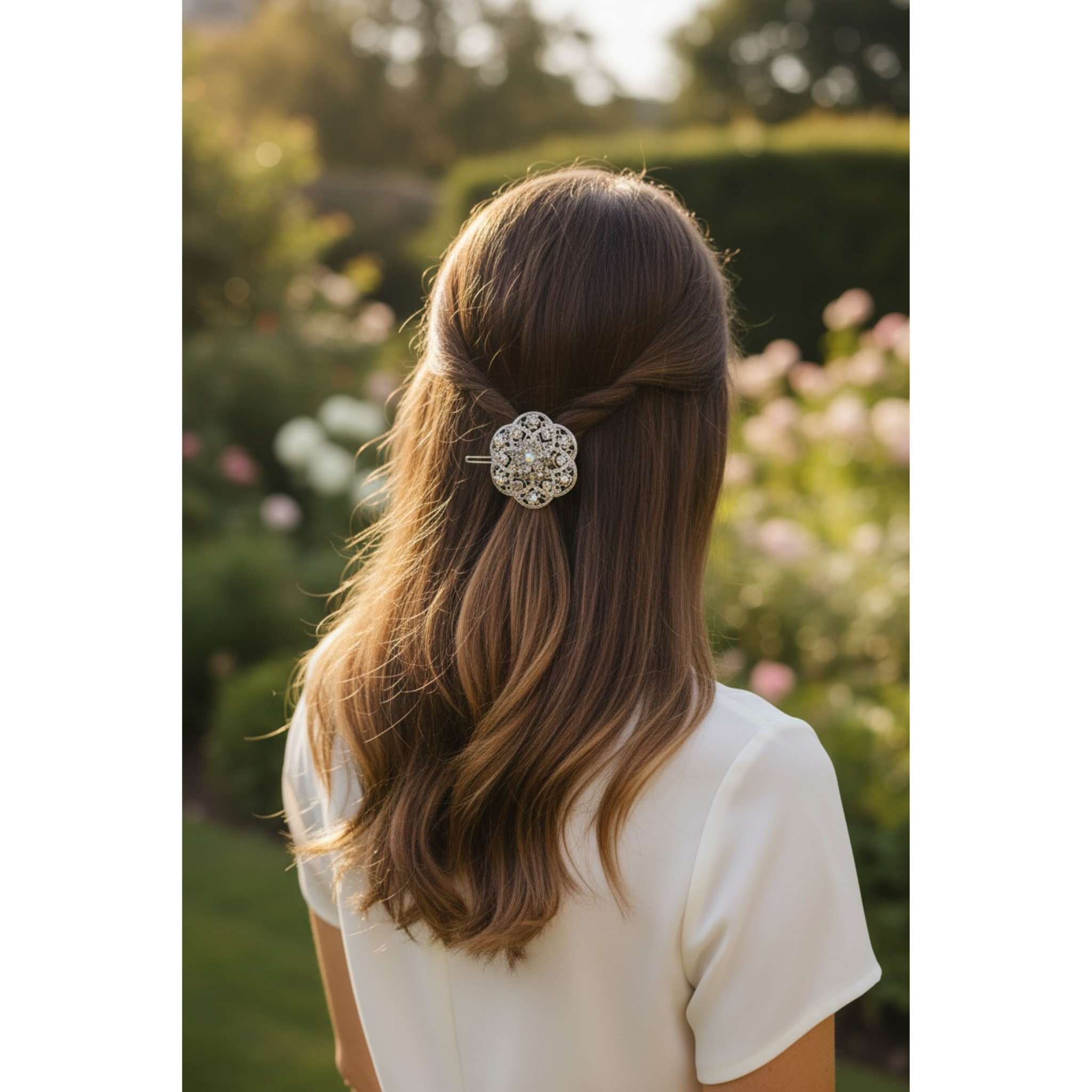 Person with a decorative hair clip in their hair, standing outdoors with greenery in the background