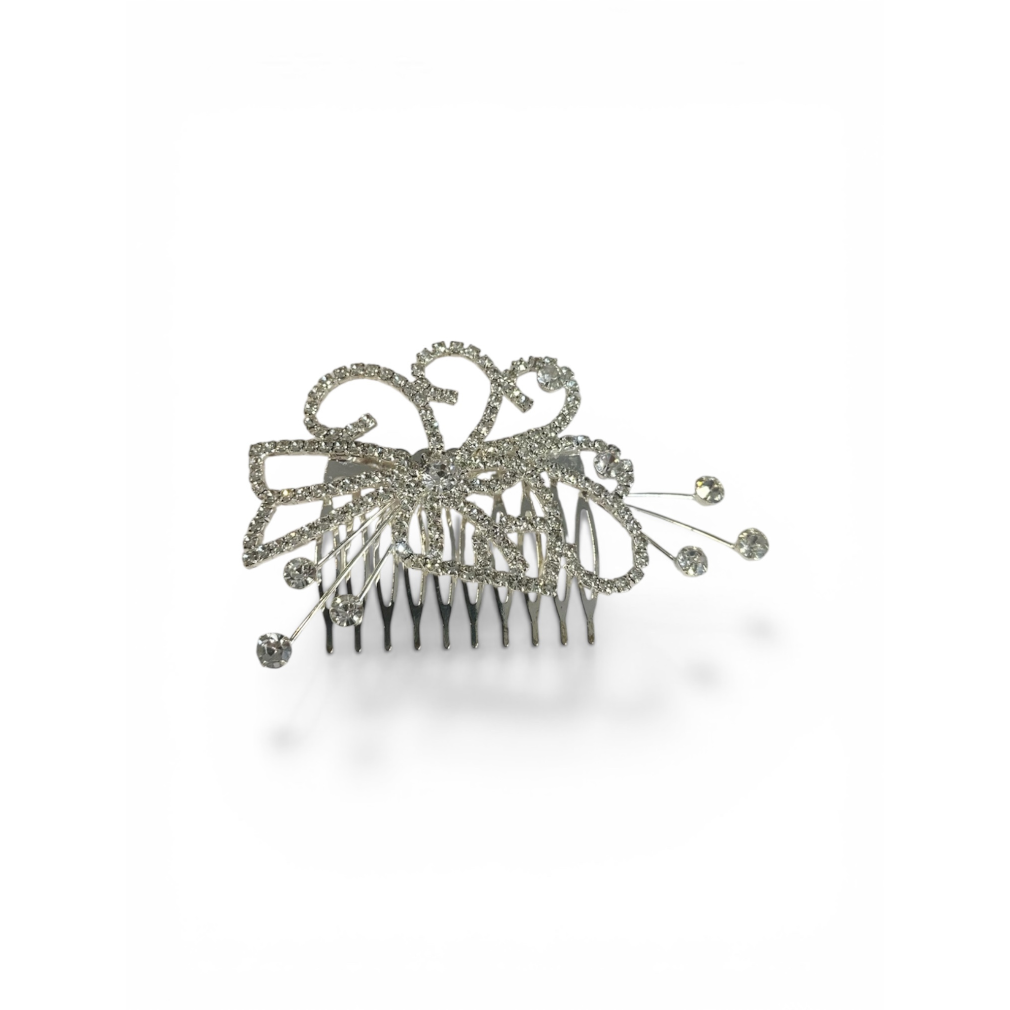 Silver hair comb with decorative elements on a white background