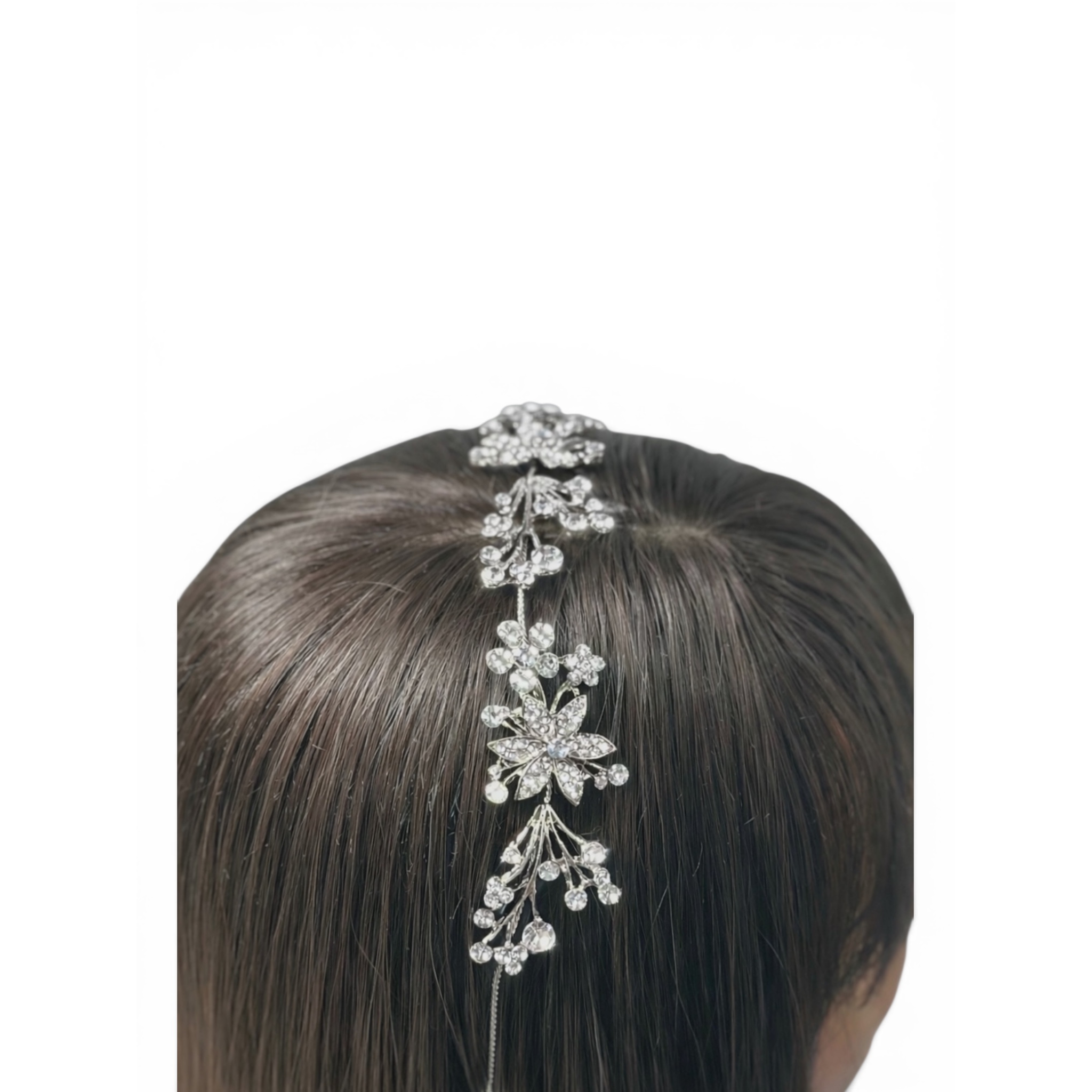Silver color headband on a woman's head against a white background