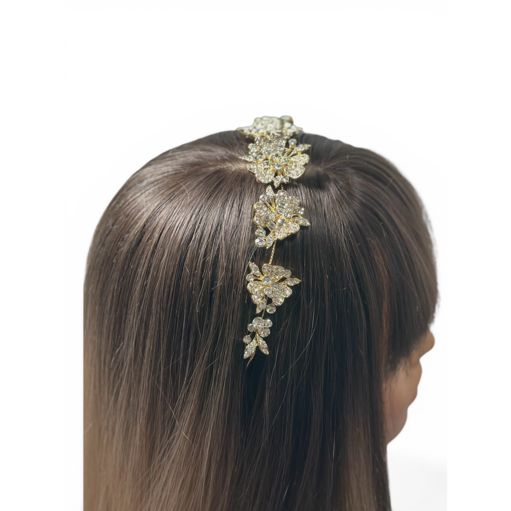 Woman wearing a decorative headband with floral design on a white background