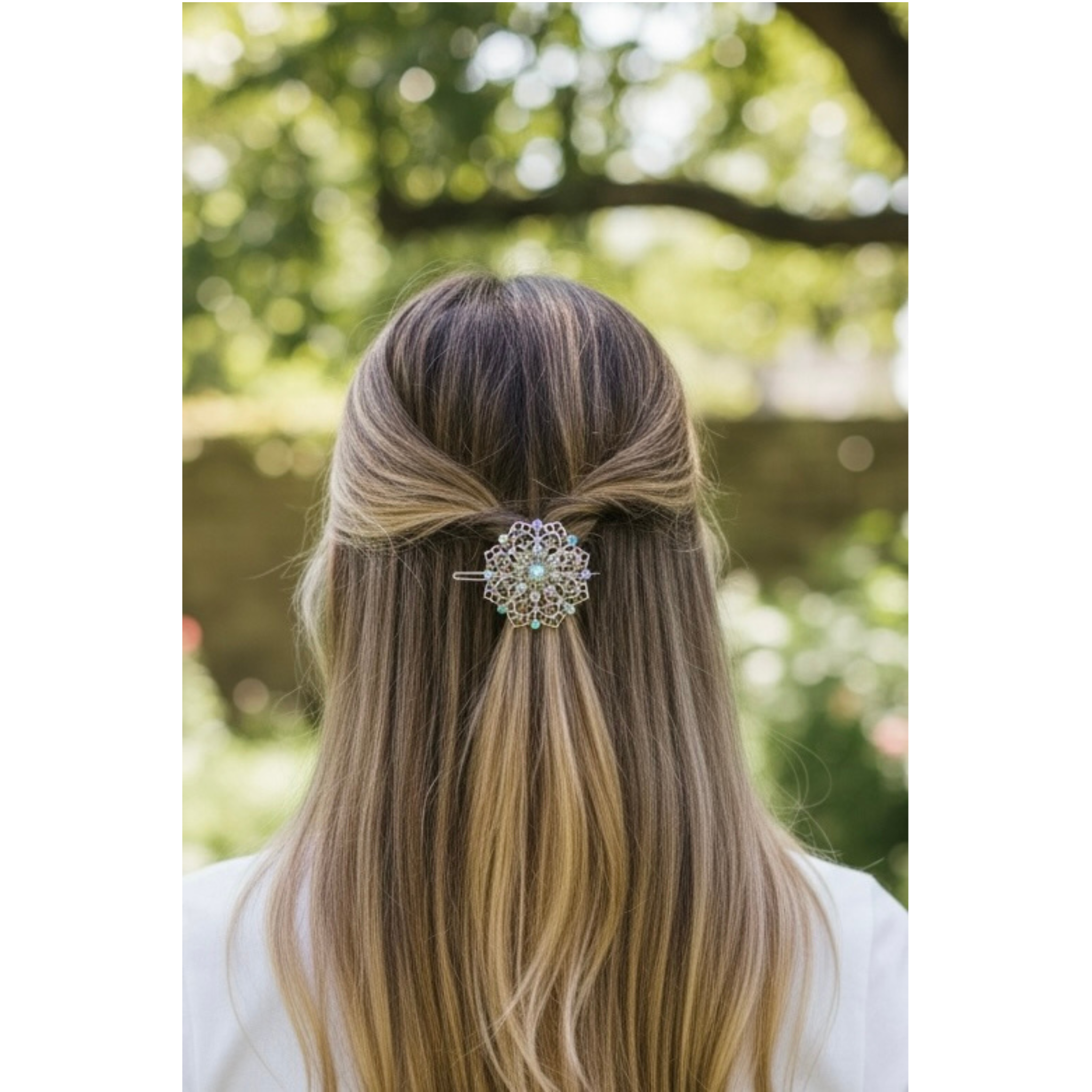 Long hair with a decorative hairpin, blurred green outdoor background