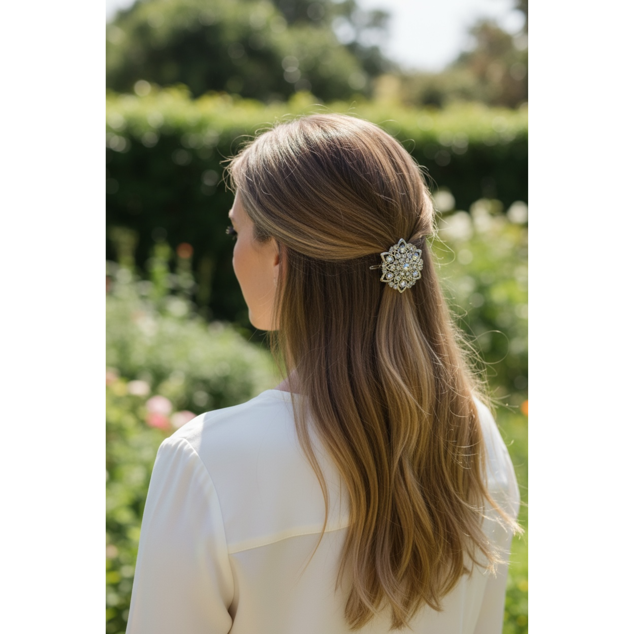 Woman with long hair wearing a decorative hair clip outdoors.