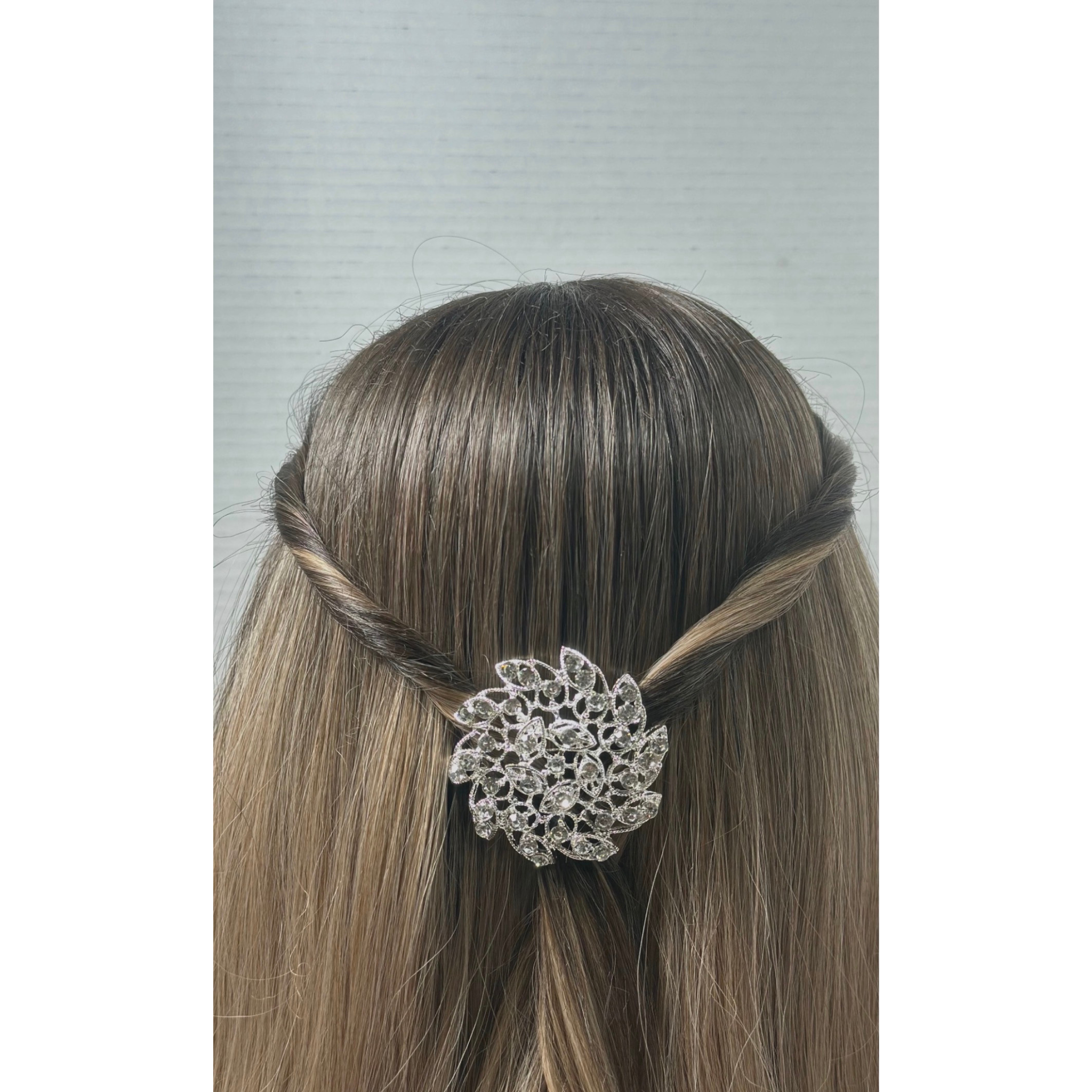 Hair accessory with decorative element on a woman's head against a neutral background