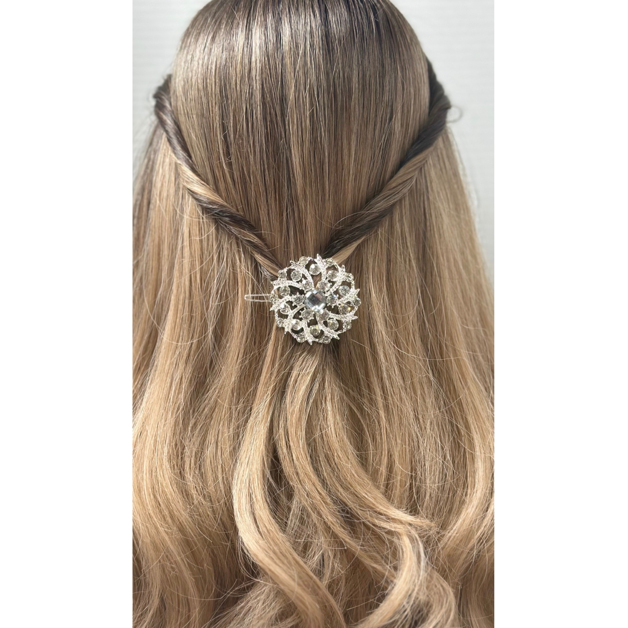 Hair styled with a decorative hairpin against a white background.