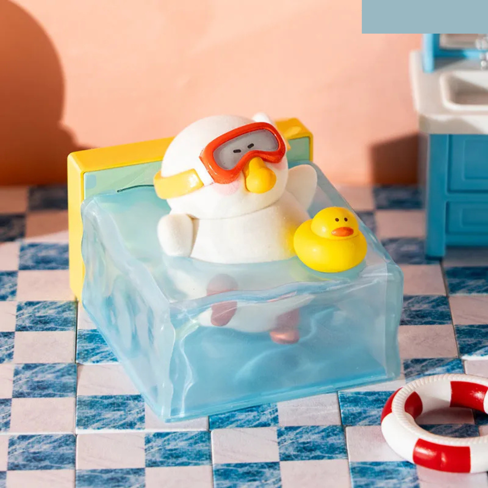 52Toys' Fat goose duck in a pool with goggles and a yellow rubber duck on a checkered floor.
