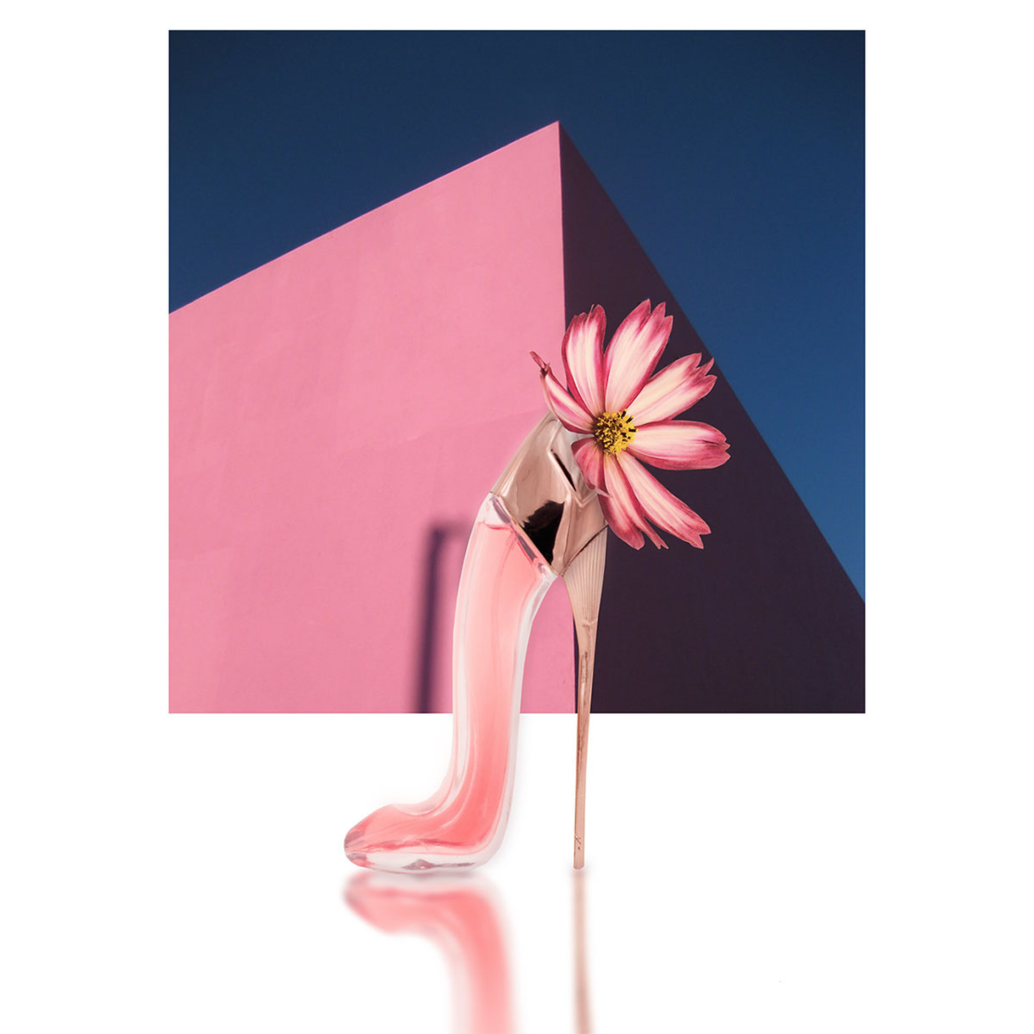 EBC Collection. Princess High Heel Pink Perfume. Perfume shaped as a High Heel. EBC Perfume with a flower against a pink and blue geometric background